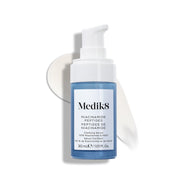 Botella de sérum Medik8 Niacinamide Peptides con un dispensador blanco, colocada sobre una superficie blanca con una pincelada de sérum blanco detrás.